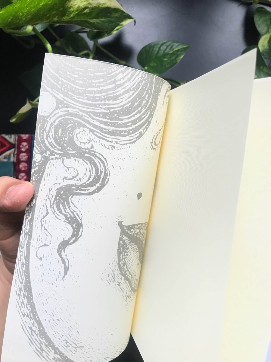 A printed inside cover, opened by hand